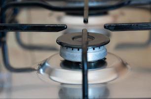 Close-up of a gas stove with no gas flowing out of it. The oven is turned off. The flame has gone out. photo