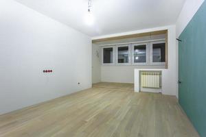 Empty unfurnished room with minimal preparatory repairs. interior with white walls photo