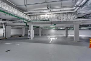 empty underground garage parking with columns and road markings photo