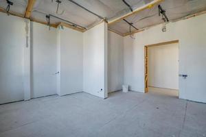 Empty unfurnished room with minimal preparatory repairs. interior with white walls photo