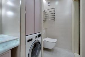 toilet and detail of a corner shower cabin with wall mount shower attachment photo