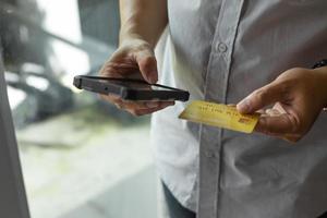 Man holding credit card and using smartphone at home, businessman shopping online, e-commerce, internet banking, spending money, working from home concept, photo