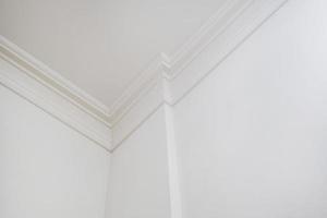 corner of ceiling and walls with intricate crown moulding. Interior construction and renovation concept. photo