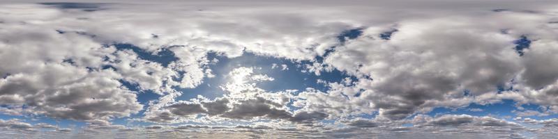 Seamless hdri panorama 360 degrees angle view blue sky with beautiful fluffy cumulus clouds with zenith for use in 3d graphics or game development as sky dome or edit drone shot photo