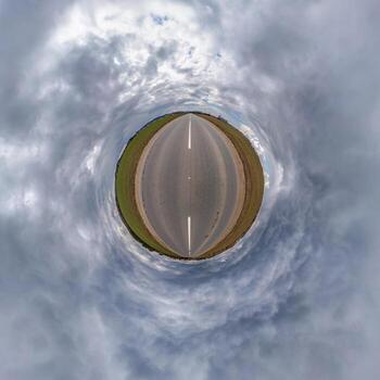 tiny planet in blue sky with beautiful clouds. Transformation of spherical panorama 360 degrees. Spherical abstract aerial view. Curvature of space. photo