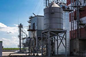 agro silos granary elevator on agro-processing manufacturing plant for processing drying cleaning and storage of agricultural products, flour, cereals and grain. photo