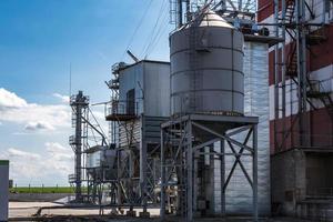 Elevador de granero de silos agrícolas en la planta de fabricación de procesamiento agrícola para el procesamiento, secado, limpieza y almacenamiento de productos agrícolas, harina, cereales y granos. foto