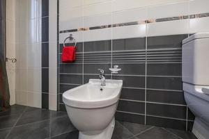 toilet or bidet in the bathroom of a hotel or apartment photo