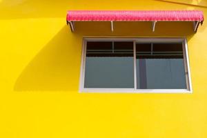 WIndow on yellow wall with red splashboard photo