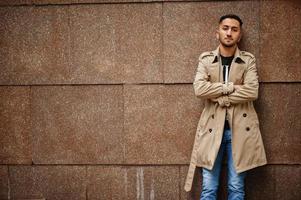 Stylish kuwaiti man at trench coat. photo