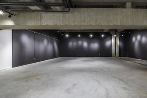 empty interior of large concrete room as warehouse or hangar with spotlights photo