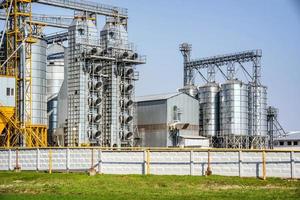 Modern Granary elevator. Silver silos on agro-processing and manufacturing plant for processing drying cleaning and storage of agricultural products, flour, cereals and grain. seed cleaning line photo