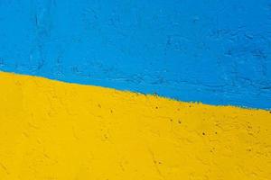 concrete wall painted in yellow and blue like Ukrainian flag, the country of victim of the aggressor photo