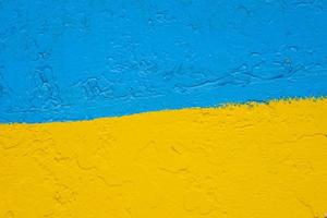 concrete wall painted in yellow and blue like Ukrainian flag, the country of victim of the aggressor photo