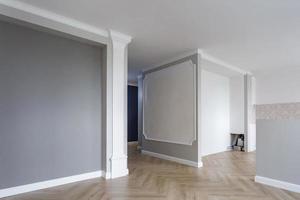 Empty room with minimal preparatory repairs with crown molding. interior of white and gray walls photo