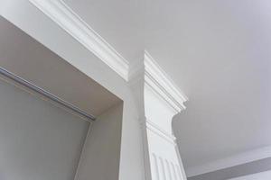 Detail of corner ceiling with intricate crown molding. photo