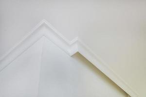 corner of ceiling and walls with intricate crown moulding. Interior construction and renovation concept. photo