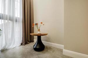 decor elements of the guest room and rest room with a tea table, an armchair and a bouquet of flowers and a cup of coffee photo