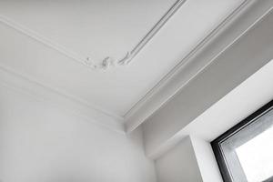 Detail of corner ceiling cornice with intricate crown molding. photo