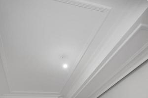 Detail of corner ceiling cornice with intricate crown molding. photo