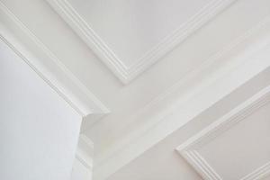 Detail of corner ceiling cornice with intricate crown molding. photo