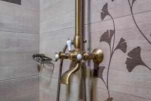 faucet and shower mixer in  corner shower cabin with wall mount shower attachment photo