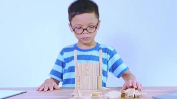 Asian boy playing with a wooden puzzle