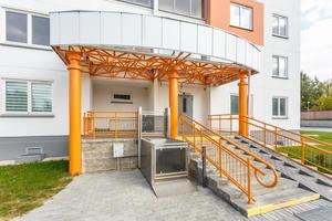 adaptation for people with disabilities, disabled people, old people, pregnant women at the entrance of a residential building. Disability stairs lift photo