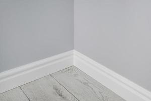 Detail of corner flooring with intricate crown molding and plinth. photo