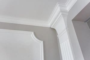 Detail of corner ceiling with intricate crown molding. photo