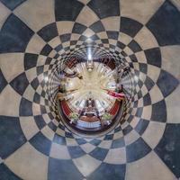 abstract tiny planet transformation of spherical panorama 360 degrees. Spherical view inside catholic gothic church. Curvature of space. photo