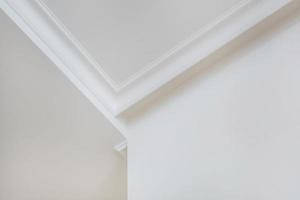 Detail of corner ceiling cornice with intricate crown molding. photo