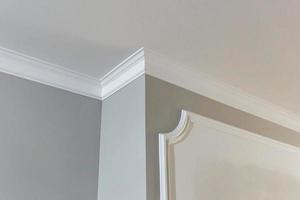 Detail of corner ceiling with intricate crown molding. photo
