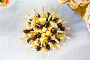 canapes from olives cheese marmalade and sausages on skewers photo