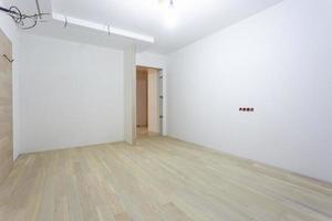 Empty unfurnished room with minimal preparatory repairs. interior with white walls photo