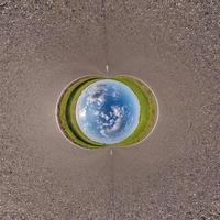 Blue little planet ball. Inversion of tiny planet transformation of spherical panorama 360 degrees. Spherical abstract aerial view. Curvature of space. photo