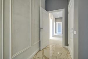 long white empty corridor in interior of entrance hall of modern apartments, office or clinic photo