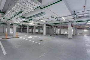 empty underground garage parking with columns and road markings photo