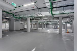 empty underground garage parking with columns and road markings photo