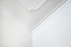 Detail of corner ceiling cornice with intricate crown molding. photo