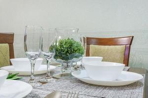 served table with a bouquet of roses in interior of modern luxure guest room in studio apartments in minimalistic style photo