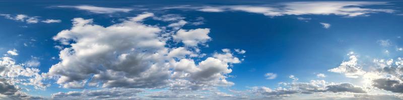 Seamless hdri panorama 360 degrees angle view blue sky with beautiful fluffy cumulus clouds with zenith for use in 3d graphics or game development as sky dome or edit drone shot photo