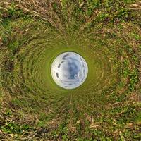 blue sky ball in middle of swirling field. Inversion of tiny planet transformation of spherical panorama 360 degrees. Curvature of space. photo