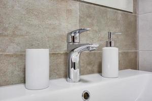 water tap sink with faucet in expensive loft bathroom or kitchen. photo