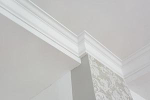 Detail of corner ceiling with intricate crown molding. photo