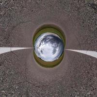 inversión de la transformación del pequeño planeta azul del panorama esférico de 360 grados. vista aérea abstracta esférica en la carretera con impresionantes nubes hermosas. curvatura del espacio. foto