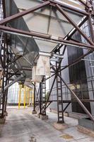 Modern Granary elevator. Silver silos on agro-processing and manufacturing plant for processing drying cleaning and storage of agricultural products, flour, cereals and grain. photo