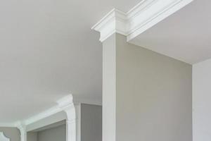 Detail of corner ceiling with intricate crown molding. photo