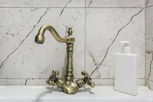 water tap sink with faucet in expensive loft bathroom or kitchen. photo