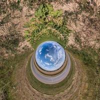 Blue little planet. Inversion of tiny planet transformation of spherical panorama 360 degrees. Spherical abstract aerial view. Curvature of space. photo